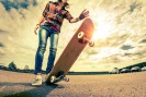 Young lady with skateboard on the road